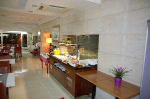 a kitchen with a counter with food on it at Hotel Suís in Sant Celoni
