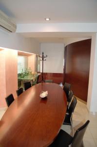 a conference room with a wooden table and chairs at Hotel Suís in Sant Celoni