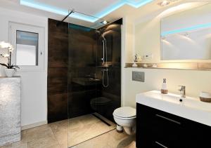a bathroom with a shower and a toilet and a sink at Thiel Apartments in Krefeld
