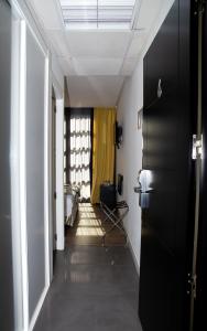 a hallway with a room with a bed and a window at Royal Tennis Club in Marbella