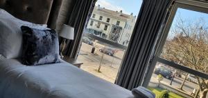 a bedroom with a bed and a large window at The Lord Street Hotel; BW Signature Collection in Southport