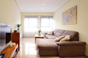 a living room with a couch and a table at City Center Apartment in Valencia