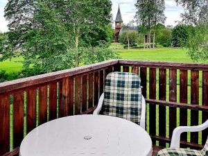 a table and two chairs sitting on a wooden deck at 5 person holiday home in LAMMHULT SVERIGE in Förhult