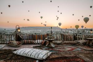 a living room with hot air balloons in the sky at Koza Cave Hotel in Göreme