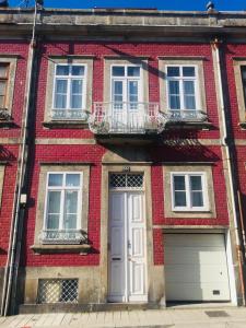 una casa de ladrillo rojo con puerta blanca en Casa Familiar do Porto, en Oporto
