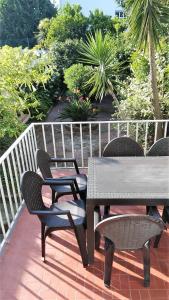 a wooden table and chairs on a patio at Casa Familiar do Porto in Porto