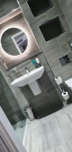 a bathroom with a sink and a mirror at The Lord Street Hotel; BW Signature Collection in Southport