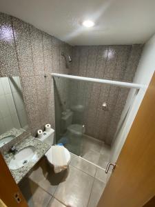 a bathroom with a shower and a sink and a toilet at Rota 232 Hotel Caruaru in Caruaru