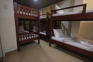 a group of bunk beds in a room at Monte casa de Rico in Vigan