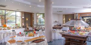 a buffet table filled with lots of different types of food at Athina Palace Resort & Spa in Agia Pelagia