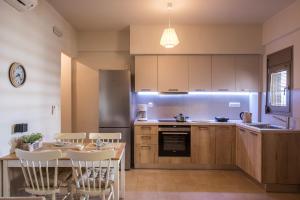 a kitchen with a table and a dining room at Caravel Apartments Stalis in Stalida