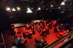 a large group of people sitting in a theatre at Unique, cosy, Lake District artist hideaway - 5 bd in Millom