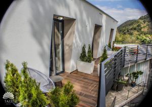 a balcony of a house with a wooden deck at Hotel Tazz - River Front Oasis Collection in Bihać