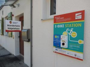 a sign on the side of a building with a bike station at Höhengasthof Wanderheim Nägelehaus in Albstadt