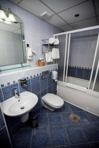 a bathroom with a sink and a toilet and a mirror at Hotel Srbija in Vršac