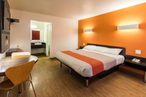 a hotel room with a bed and a desk at Motel 6-Stephenville, TX in Stephenville