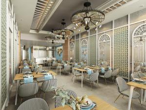 a restaurant with tables and chairs and a chandelier at PAMPHYLIA HOTEL in Valencia