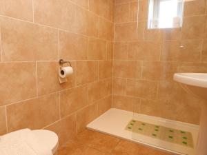 ein Badezimmer mit Dusche, Toilette und Waschbecken in der Unterkunft Katy's Cottage in Skipton