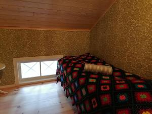 a bedroom with a bed in a room with a window at Huset Alvina in Korsnäs