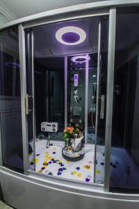 a bathroom with a shower with a sink in it at GolfView Suites & Conference Center in Ikeja