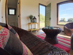 a living room with a couch and a window at Nenquen Lodge in Santa Cruz