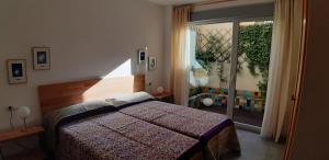 um quarto com uma cama e uma porta de vidro deslizante em Apartamento en el Casco Histórico, frente a la Colegiata de San Isidoro, em León