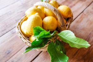 a basket filled with lemons on a wooden table at Lisbon Country Villa in Oeiras