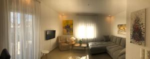 a living room with a couch and a table at Exclusive Airport Apartment in Kelsterbach