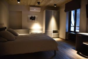 a bedroom with a large bed and a window at Airfield - Airport in Luxembourg
