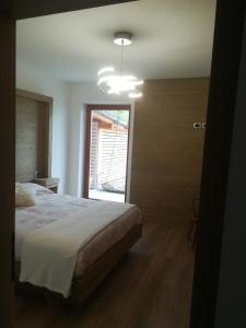 a bedroom with a large bed and a window at B&B antico tabià dolomitico in Santo Stefano di Cadore
