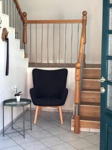 a chair and a table next to a staircase at Apartment Hoyerhagen in Hoyerhagen