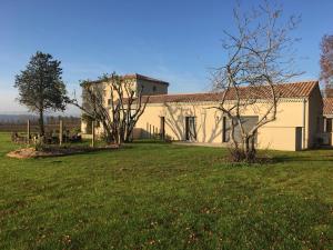 a large building with a grass yard in front of it at Gîte PLACE FOR YOU in Malissard