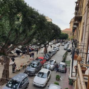 a row of cars parked on a city street at Opera Prima 28 in Palermo