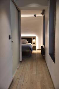 a bedroom with a bed and a wooden floor at Airfield - Airport in Luxembourg