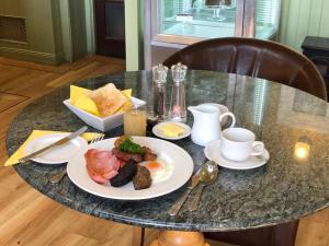 a table with a plate of breakfast food on it at Kilconquhar Castle Estate in Kilconquhar