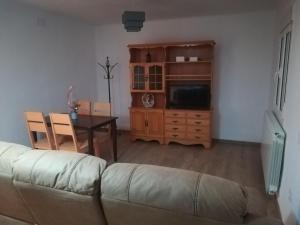 a living room with a couch and a table at san leon in Teruel
