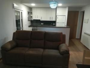 a living room with a couch and a kitchen at san leon in Teruel