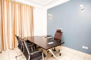 杜阿拉的住宿－Residence Le Carat Bonapriso，一间会议室,配有木桌和椅子