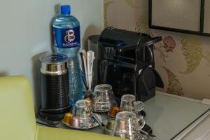 a counter top with cups and a bottle of water at Sea View D4 in Dublin