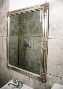 a mirror over a sink in a bathroom at Ayana Central House in Oradea