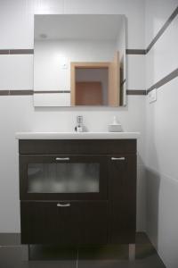 a bathroom with a sink and a mirror at Natura Apartments in Chelva