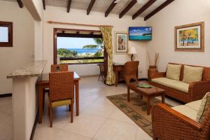 a living room with a couch and a table at Sugar Cane Club Hotel & Spa in Saint Peter