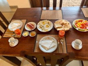 a wooden table with plates of food on it at Aayu Lagoon in Negombo