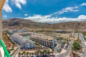 eine Luftaufnahme eines Resorts mit Bergen im Hintergrund in der Unterkunft Oasis in Los Cristianos