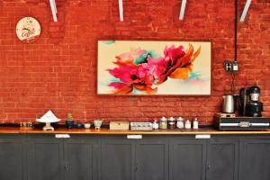 a brick wall with a painting of flowers on it at DEL900 Hostel Boutique in Buenos Aires