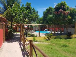 a fence in front of a swimming pool at Casas Barra Sol in Barra Grande