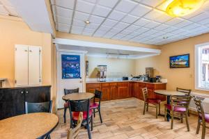 a room with tables and chairs and a kitchen at Econo Lodge Beach and Boardwalk in Atlantic City