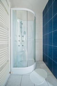 a bathroom with a shower with a glass door at Penzión Exclusive in Trenčín