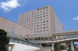 a large building with a clock on the top of it at Oriental Hotel Tokyo Bay in Tokyo