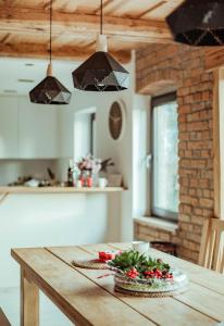 a wooden table in a kitchen with a table sidx sidx sidx at Dom Mazurski Tumiany 3 B in Tumiany